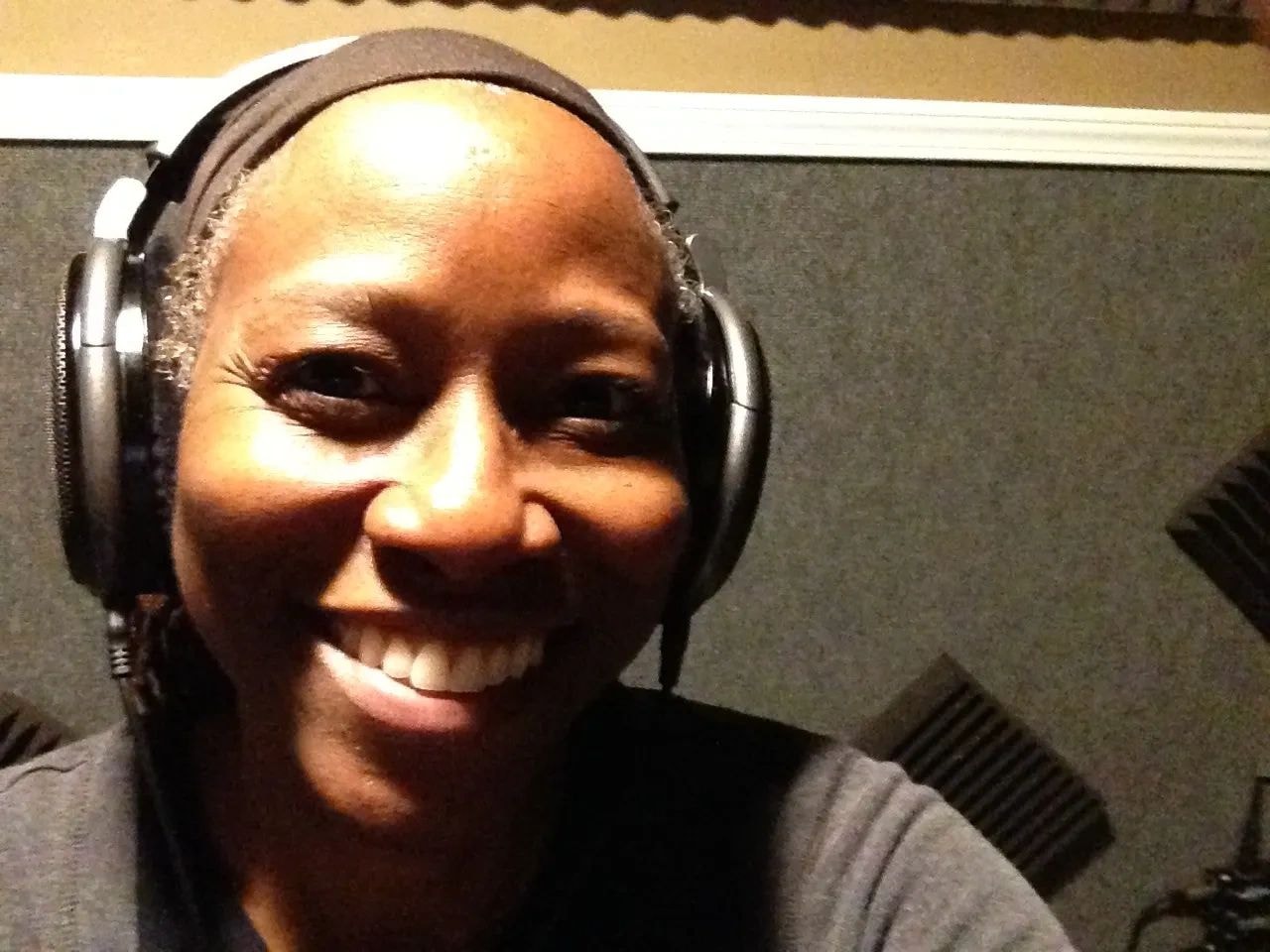 Jacqui Sutton wearing headphones in a recording studio